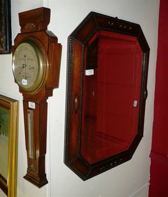 Lot 782 - An oak wall mirror and a walnut cased barometer