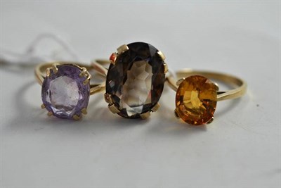 Lot 80 - Three 9ct gold rings set with an amethyst, a smokey quartz and a citrine