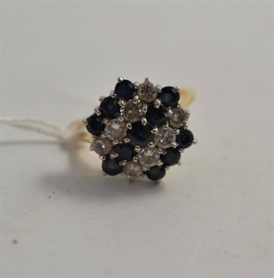 Lot 83 - A diamond and sapphire cluster ring