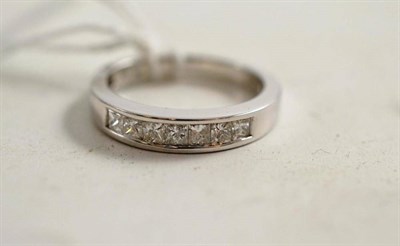 Lot 100 - A princess cut diamond half eternity ring, stamped ";14k"