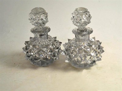 Lot 115 - A pair of cut glass scent bottles and stoppers