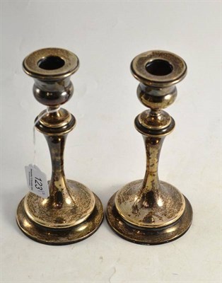 Lot 123 - Pair of loaded silver candlesticks