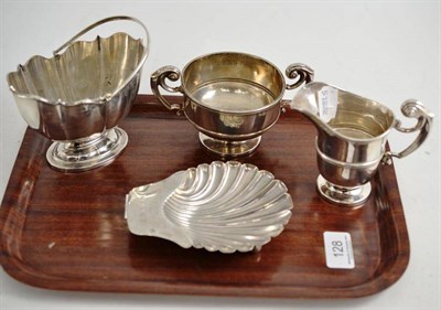 Lot 128 - A shell butter dish, cream jug, sugar bowl and sugar basket (4)