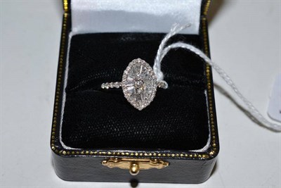 Lot 171 - A marquise shaped diamond cluster ring, set with round brilliant cut and tapered baguette cut...