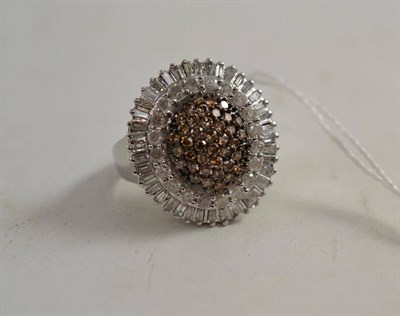 Lot 184 - A cognac and white diamond cluster ring