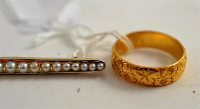 Lot 187 - A 22ct gold patterned band ring and a seed pearl brooch, stamped '15ct' and 'PLATM'