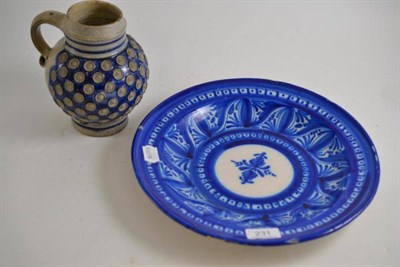 Lot 231 - A blue and white tin glazed charger and a German stoneware mug