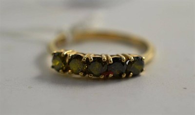 Lot 282 - A 9ct gold five stone peridot ring