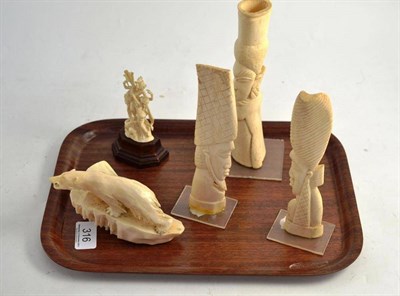 Lot 316 - A marine ivory carving of a polar bear, a well carved model of two Indian figures and three African