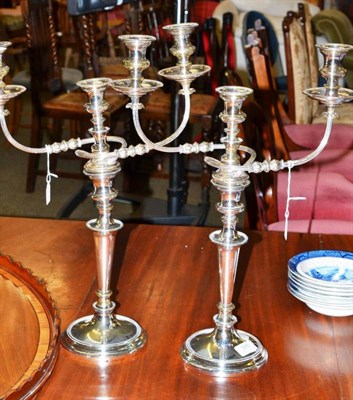 Lot 395 - Pair of electroplated double branch candelabra