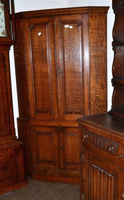 Lot 498 - Standing oak corner cabinet on cupboard base