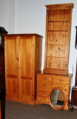 Lot 500 - Modern four height pine chest of drawers, open bookcase, an oval wall mirror and double...