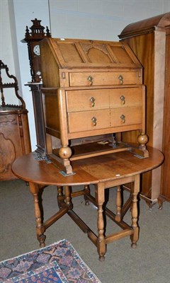 Lot 506 - A light oak drop leaf table and a small oak bureau