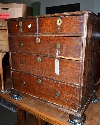 Lot 524 - A small oak four height chest of drawers on bun feet