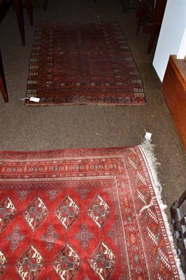 Lot 543 - An Afghan Tekke rug North West Afghanistan, the claret field with three columns of quartered...