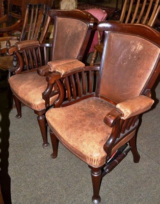 Lot 559 - Pair of mahogany elbow chairs with leather upholstery and a rocking chair (3)