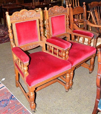 Lot 561 - A pair of carved oak open armchairs with red velvet upholstery