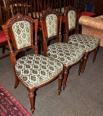 Lot 567 - Three late Victorian walnut framed salon chairs with upholstered seats and backs