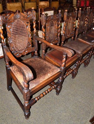 Lot 575 - A carved oak carver chair and four dining chairs with caned backs