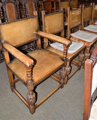 Lot 579 - A set of eight oak framed dining chairs with leather upholstery including two carvers