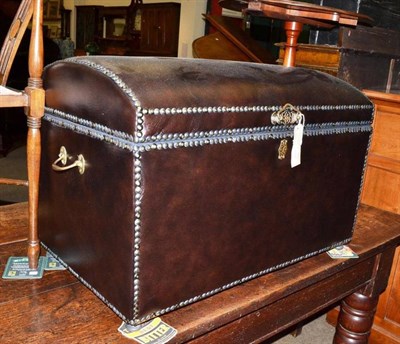 Lot 597 - A leather dome-top trunk