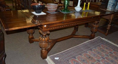 Lot 618 - An oak draw leaf dining table with heavily carved legs