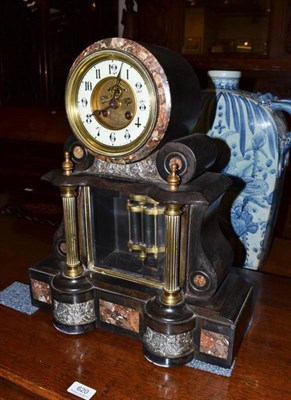 Lot 619 - A black slate striking mantel clock