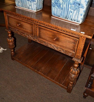 Lot 623 - A reproduction oak two tier serving table with two drawers