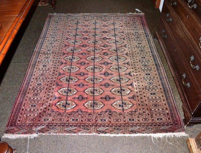 Lot 630 - A Tekke rug North West Afghanistan, the soft rose field with three columns of quartered guls...