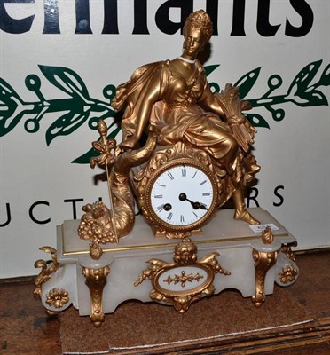 Lot 634 - A French striking gilt metal and onyx mantel clock