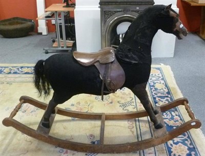 Lot 639 - Large 19th century carved Pine rocking horse with glass eyes, recovered and patched with black...