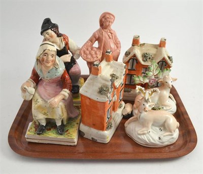 Lot 21 - Two Staffordshire house money boxes, pottery stag and doe figures, pair of pottery figures and...