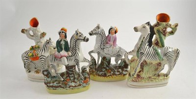 Lot 23 - A pair of Staffordshire zebra figural groups and two Staffordshire zebra spill vases (4)