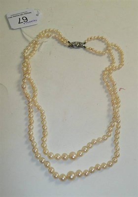 Lot 67 - A two strand cultured pearl lotus necklace, clasp stamped '9ct'