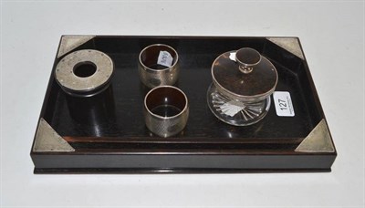 Lot 127 - A silver mounted ebony dressing table tray, a glass jar and tortoiseshell and silver cover, a...