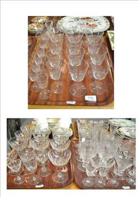 Lot 174 - A part suite of monogrammed glasses, champagne glasses and other glassware on three trays