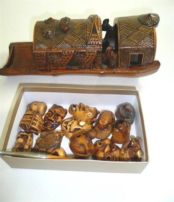 Lot 197 - Fifteen modern Japanese wood netsukes, a bamboo boat and a pipe (17)