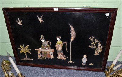 Lot 209 - A Japanese hardwood panel depicting two figures amongst a landscape