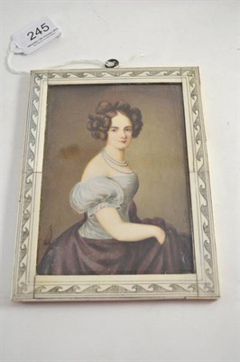 Lot 245 - A miniature of a lady wearing pearls, white top and plum coloured skirt signed W. Fischer, in ivory