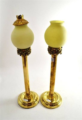 Lot 276 - A pair of candle lamps with yellow shades