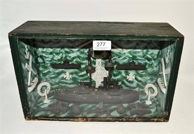 Lot 277 - A First World War German diorama, of a gunboat with tanks, biplanes, mines, crossed oars, iron...