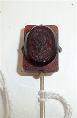 Lot 331 - A gilt metal stick pin mounted with a carved cameo mount of a Grecian warrior