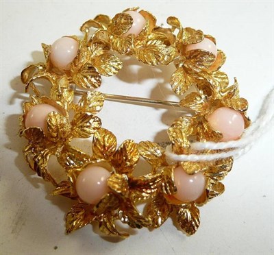 Lot 334 - A coral set floral brooch stamped '18K'