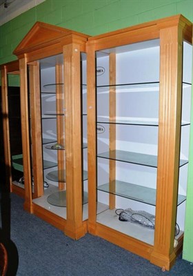 Lot 421 - A modern break front cabinet with glass shelves, central circular glass display shelves and...