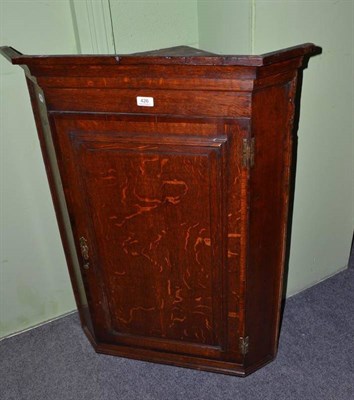 Lot 426 - A Georgian oak corner cupboard