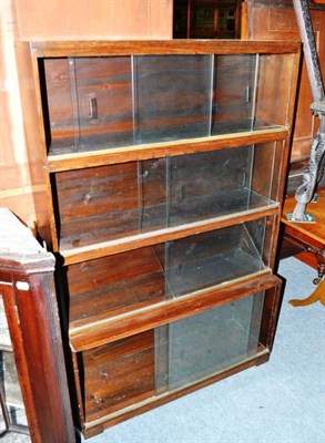 Lot 432 - An oak four height stacking bookcase with sliding glass doors