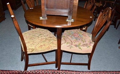 Lot 438 - A 19th century mahogany drop leaf table and a set of four mahogany dining chairs