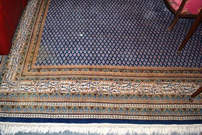 Lot 460 - Large wool ground modern Persian style carpet, the mid indigo field with an all over design of...