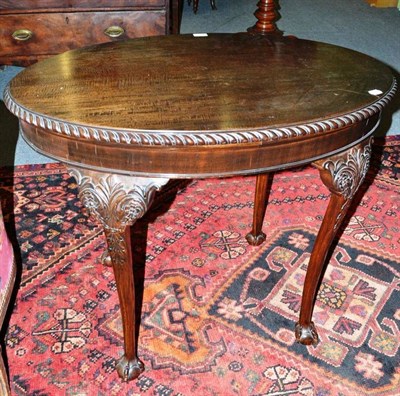 Lot 464 - A carved mahogany oval occasional table