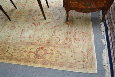 Lot 502 - Pakistan carpet probably Lahore, the ivory field of angular vines enclosed by floral borders,...